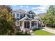 Charming two-story home with a well-maintained lawn, inviting porch, and beautiful, mature landscaping at 16376 Stonefeld Pl, Parker, CO 80134