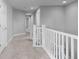Upstairs hallway bathed in natural light, featuring neutral carpet and modern white trim at 16376 Stonefeld Pl, Parker, CO 80134