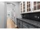 Kitchen area featuring granite countertops, custom cabinetry, and hardwood floors throughout the area at 16376 Stonefeld Pl, Parker, CO 80134