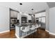 Kitchen with stainless steel appliances, a large island with seating, and custom cabinets at 16376 Stonefeld Pl, Parker, CO 80134