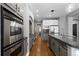 Spacious kitchen featuring stainless steel appliances, granite countertops, and custom cabinets at 16376 Stonefeld Pl, Parker, CO 80134