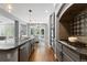 Modern kitchen features stainless appliances, granite countertops and view to living area at 16376 Stonefeld Pl, Parker, CO 80134