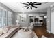 Elegant living room featuring plush seating, a ceiling fan, and an open floor plan to the kitchen at 16376 Stonefeld Pl, Parker, CO 80134