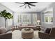 Sun-lit living room provides generous seating options around a decorative ottoman at 16376 Stonefeld Pl, Parker, CO 80134