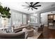 Well-lit living room, showing ample seating and view into adjoining dining and kitchen at 16376 Stonefeld Pl, Parker, CO 80134