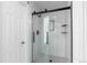 Modern tiled shower with glass enclosure, black hardware, and built in shelves at 16376 Stonefeld Pl, Parker, CO 80134