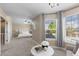 Bright main bedroom sitting area with many windows and natural light at 16376 Stonefeld Pl, Parker, CO 80134