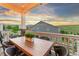Back deck with an outdoor dining table perfect for entertaining with a sunset view at 17335 W 94Th Ave, Arvada, CO 80007