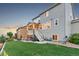 Back exterior of a two story house with a deck, patio, and green lawn at 17335 W 94Th Ave, Arvada, CO 80007