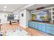 Spacious basement with a large TV and custom built-in shelving and cabinets at 17335 W 94Th Ave, Arvada, CO 80007