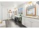 Elegant bathroom with double vanity, granite countertops, modern fixtures, and natural light at 17335 W 94Th Ave, Arvada, CO 80007