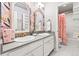 Charming bathroom with double sinks, decorative wallpaper and access to a bathtub/shower combo at 17335 W 94Th Ave, Arvada, CO 80007