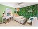 Cozy bedroom with a vibrant green wall, complemented by a comfortable bed and stylish decor at 17335 W 94Th Ave, Arvada, CO 80007