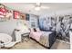 Stylish bedroom with a city themed wallpaper, desk area, and bright natural light at 17335 W 94Th Ave, Arvada, CO 80007