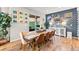 Dining area with hardwood floors, modern decor, and sliding door to outdoor space at 17335 W 94Th Ave, Arvada, CO 80007