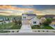 Charming two-story home with gray siding, green shutters, landscaped yard, and a two car garage at 17335 W 94Th Ave, Arvada, CO 80007