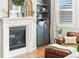 Close up of fireplace with built-in shelving, mantle decor, and hardwood floors at 17335 W 94Th Ave, Arvada, CO 80007