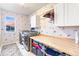 Well-organized laundry room with modern appliances, ample storage, and a practical folding table at 17335 W 94Th Ave, Arvada, CO 80007