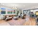 Bright, open-concept living room with modern decor, hardwood floors, and large windows offering lots of natural light at 17335 W 94Th Ave, Arvada, CO 80007