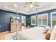 Comfortable main bedroom featuring shuttered windows, warm lighting, and adjoined ensuite bathroom, creating a private retreat at 17335 W 94Th Ave, Arvada, CO 80007