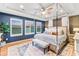 Luxurious main bedroom with a four-poster bed, elegant furnishings, and natural light from shuttered windows at 17335 W 94Th Ave, Arvada, CO 80007