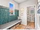 Inviting mud room with a comfortable bench, practical storage baskets, decorative wallpaper, and attractive sunset view at 17335 W 94Th Ave, Arvada, CO 80007