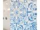 The shower features eye-catching blue and white patterned tile and sleek fixtures at 17335 W 94Th Ave, Arvada, CO 80007