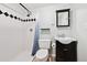 Updated bathroom featuring a walk-in shower and modern vanity at 10378 W Weaver Ave, Littleton, CO 80127