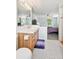 Bright bathroom with white tile, a fan, and view of the bedroom at 10378 W Weaver Ave, Littleton, CO 80127