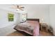 Comfortable bedroom featuring a fan, windows, and neutral decor at 10378 W Weaver Ave, Littleton, CO 80127