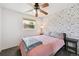 Inviting bedroom with a unique wallpaper and a fan at 10378 W Weaver Ave, Littleton, CO 80127