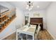 Bright dining room with a modern table and a piano near the staircase at 10378 W Weaver Ave, Littleton, CO 80127