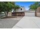 Beautiful two-story home with a brick facade, double doors, and an inviting front yard with stone landscaping at 10378 W Weaver Ave, Littleton, CO 80127
