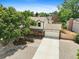 Charming two-story home with a large front yard, mature tree, and a two-car garage at 10378 W Weaver Ave, Littleton, CO 80127