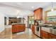 Open kitchen featuring wood cabinets, stainless steel appliances, and an island at 10378 W Weaver Ave, Littleton, CO 80127