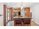 Stylish kitchen with an island, granite countertops, pendant lighting, and stainless steel appliances at 10378 W Weaver Ave, Littleton, CO 80127