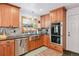 Modern kitchen with stainless steel appliances, granite countertops, tile backsplash, and ample cabinet space at 10378 W Weaver Ave, Littleton, CO 80127