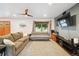 Comfortable living room with a large window, modern furnishings, and an entertainment center at 10378 W Weaver Ave, Littleton, CO 80127