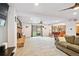 Spacious living room flowing into an updated kitchen with a brick fireplace and sliding glass doors to the yard at 10378 W Weaver Ave, Littleton, CO 80127