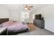 Bright main bedroom featuring a fan, large windows, an ensuite, and ample closet space at 10378 W Weaver Ave, Littleton, CO 80127