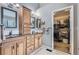 Well-appointed bathroom with double sinks, framed mirrors, and walk-in closet at 9680 Burberry Way, Highlands Ranch, CO 80129