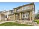 Charming two-story home featuring a covered front porch, manicured lawn, and attached garage at 9680 Burberry Way, Highlands Ranch, CO 80129