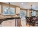 Kitchen features granite counters, stainless appliances, and a view to the deck area at 9680 Burberry Way, Highlands Ranch, CO 80129