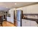 Kitchen with white cabinets, stainless appliances, hardwood floors, and ample storage at 9680 Burberry Way, Highlands Ranch, CO 80129