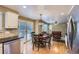 Kitchen and eat-in area flows into the living room, featuring stainless appliances at 9680 Burberry Way, Highlands Ranch, CO 80129