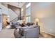 Spacious living room features vaulted ceilings, a staircase and many windows for natural light at 9680 Burberry Way, Highlands Ranch, CO 80129