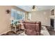 Inviting living room featuring large windows and a ceiling fan at 9680 Burberry Way, Highlands Ranch, CO 80129