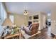 Comfortable living room features a fireplace, built-in shelves, and neutral tones at 9680 Burberry Way, Highlands Ranch, CO 80129