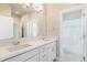 Clean bathroom with double sinks, white cabinets, and a bathtub at 27750 E Lakeview Dr, Aurora, CO 80016