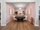 Elegant dining room features a large table, chandelier, and light pink walls at 27750 E Lakeview Dr, Aurora, CO 80016